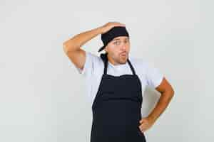 Free photo baker man holding hand on head in t-shirt