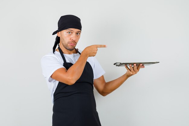 Baker man holding metallic tray