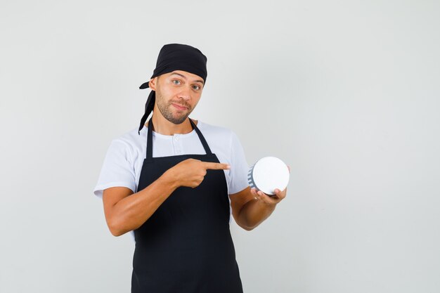 Baker man pointing at gift box in t-shirt