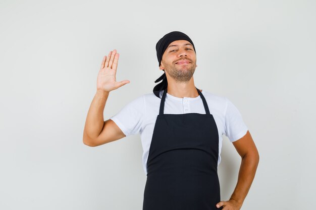 Baker man waving hand for greeting in t-shirt