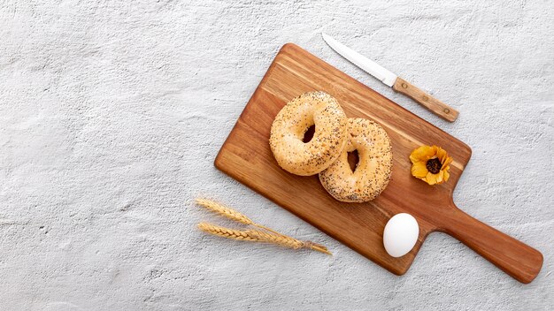 Bakery bread doughnuts on wooden board with flower