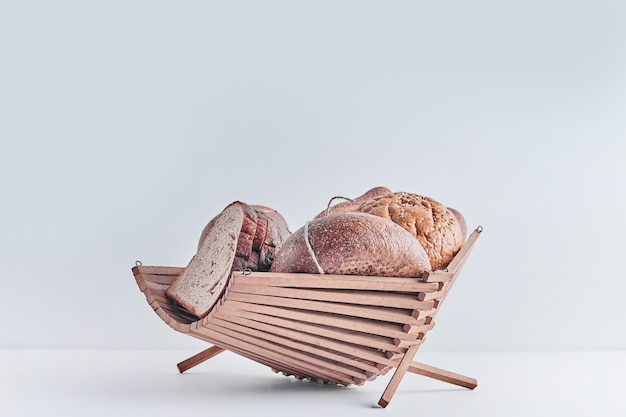 Free photo bakery products on white table in a wooden basket.