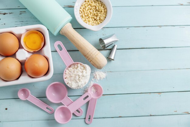 Baking concept with ingredients on blue background Top View