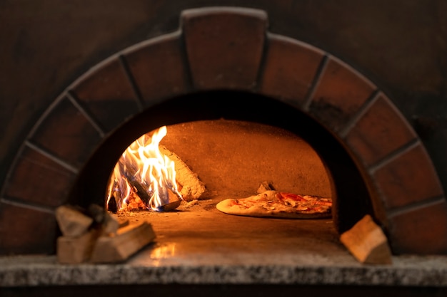 Baking delicious pizza with wood fired oven