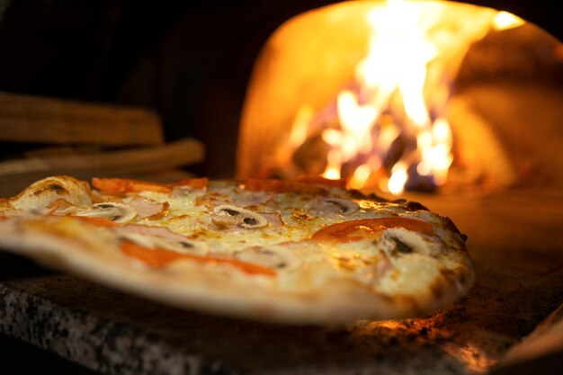 Baking delicious pizza with wood fired oven