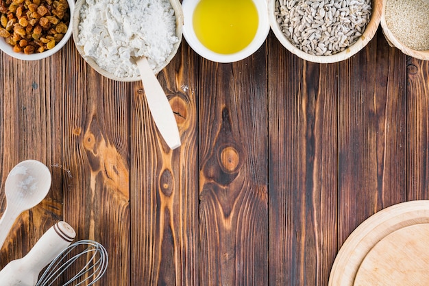 Baking ingredients in the bowl on the wooden background