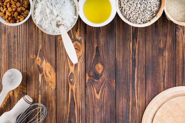 Baking ingredients in the bowl on the wooden background