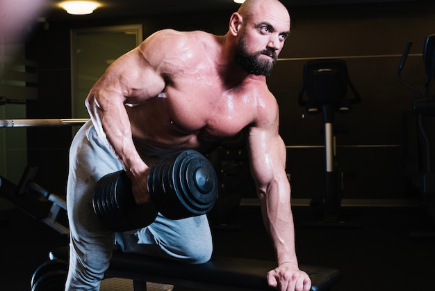 Bald man leaning on bench