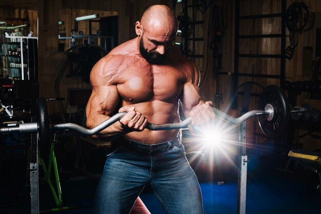 Bald man lifting barbell