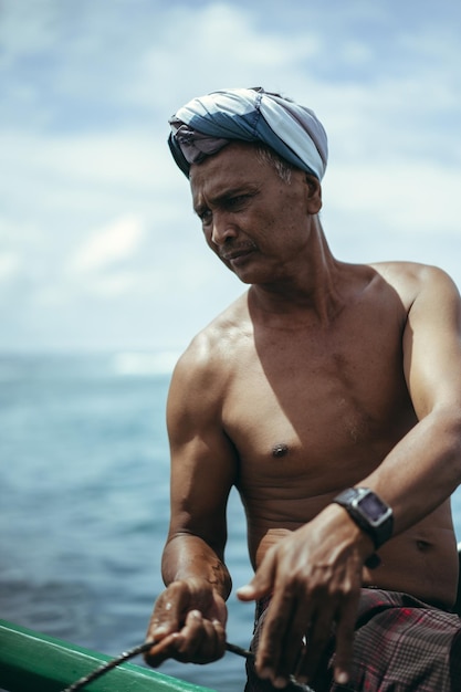 Balinese fisherman on an authentic boat in the ocean catching fish