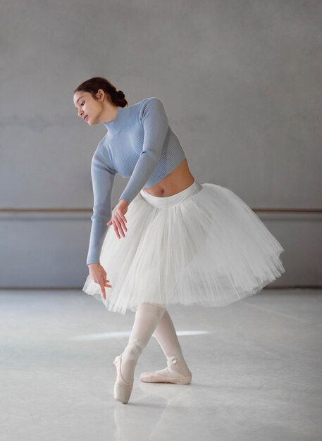 Ballerina dancing  in tutu skirt and pointe shoes