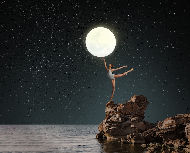 Free photo ballerina holding moon