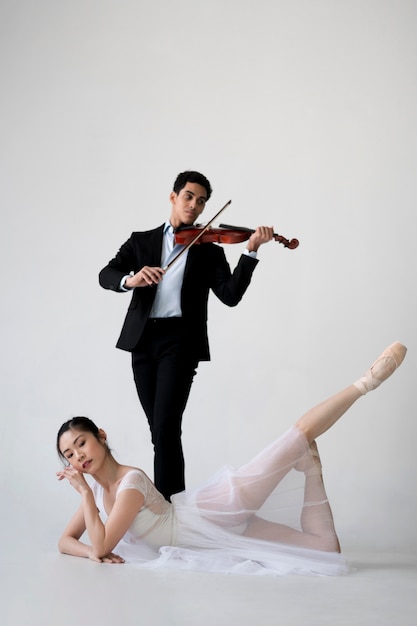 Ballerina and musician poising together