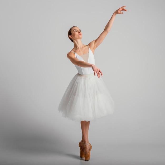 Ballerina posing with pointe shoes