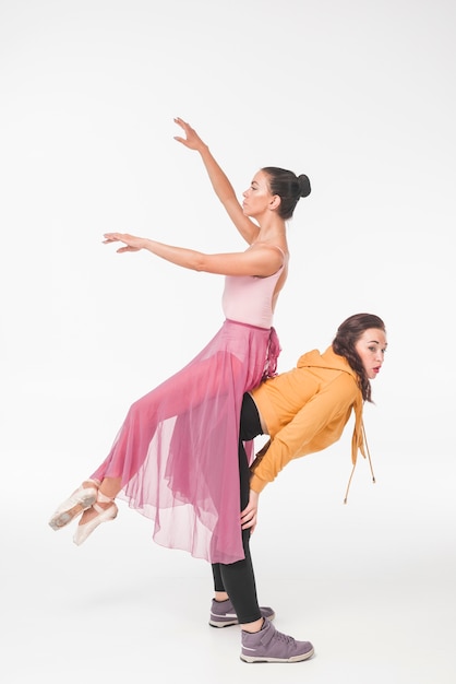 Ballerina sitting on woman's back over the white background