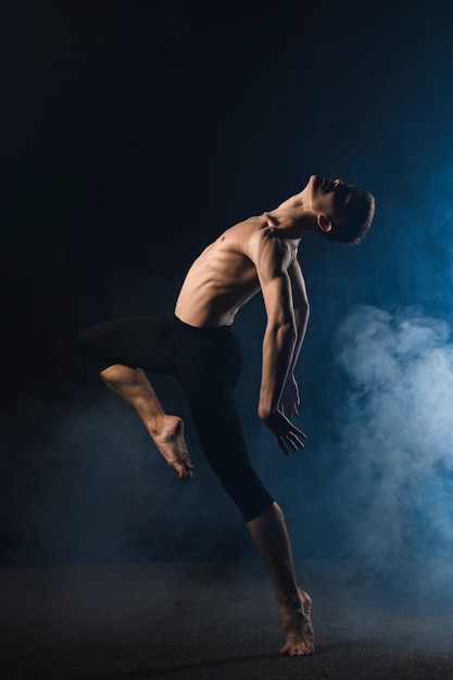 Ballerino dancing with tights and smoke