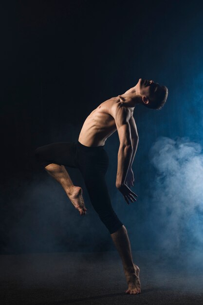 Ballerino dancing with tights and smoke