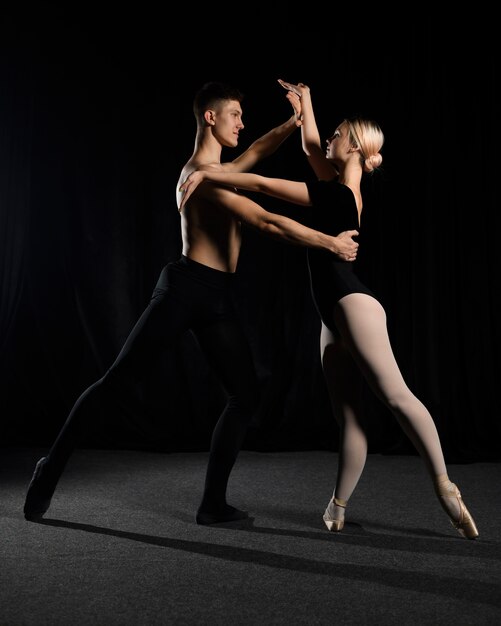 Ballet couple posing while dancing