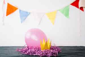 Free photo balloon crown and tinsel near flag garland