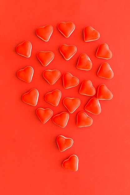 Balloon made up of heart shape candies on red background