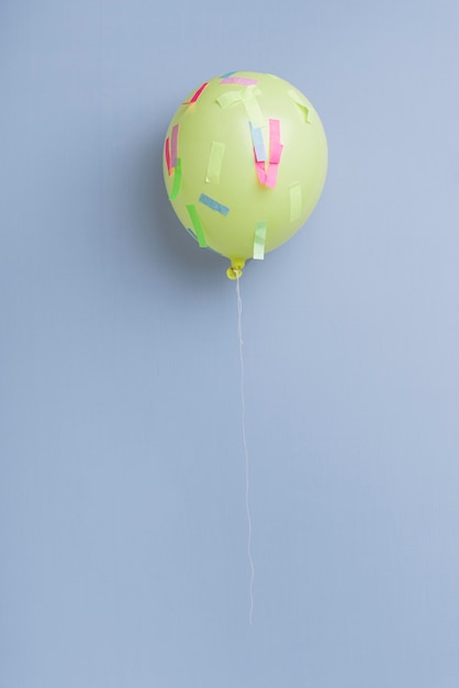 Free photo balloon with confetti on blue background