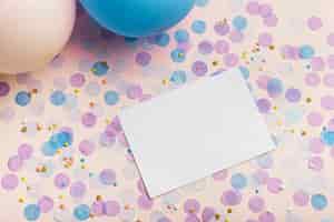 Free photo balloons and confetti on yellow background with copy space