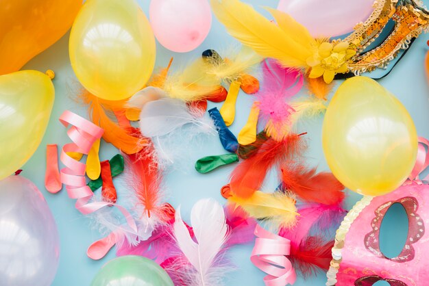Balloons near masks and feathers