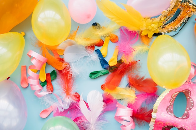 Balloons near masks and feathers