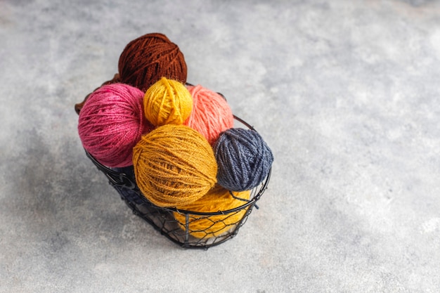 Free photo balls of yarn in different colors with knitting needles.