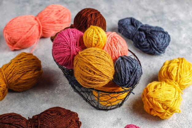 Balls of yarn in different colors with knitting needles.