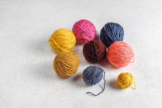 Balls of yarn in different colors with knitting needles.