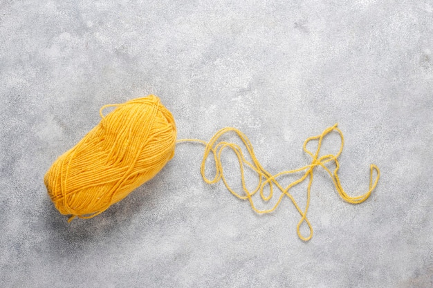 Balls of yarn in different colors with knitting needles.