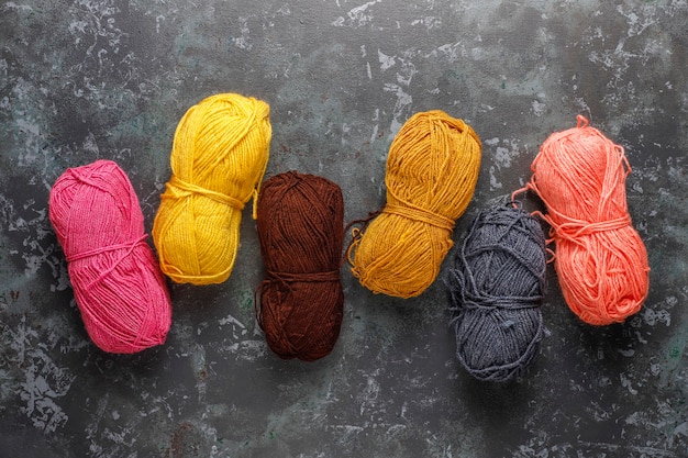 Balls of yarn in different colors with knitting needles.