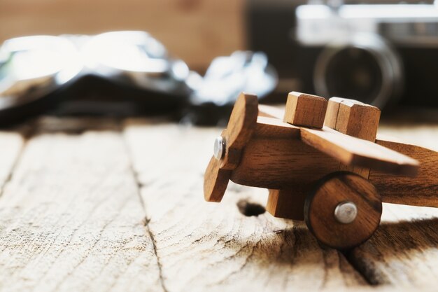 Balsa wood model airplane on desk with copy space travel concept.