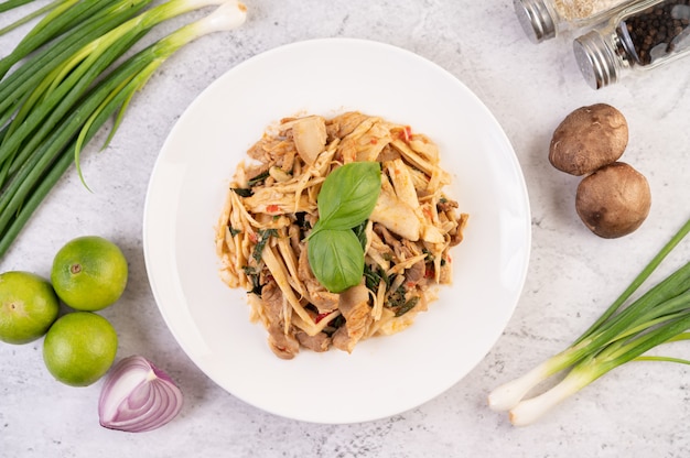 Bamboo shoot curry, add pork into a white dish.