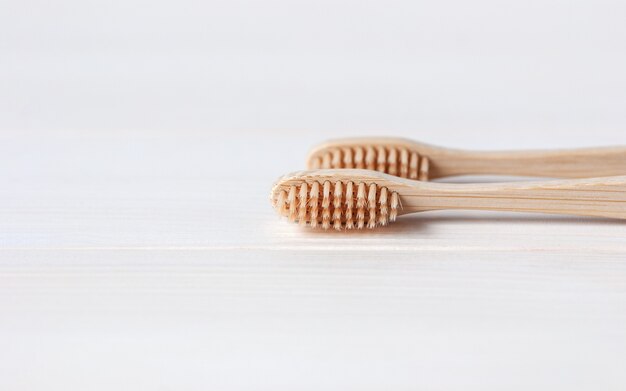 Bamboo toothbrushes on white table background  minimal eco friendly and sustainability concept