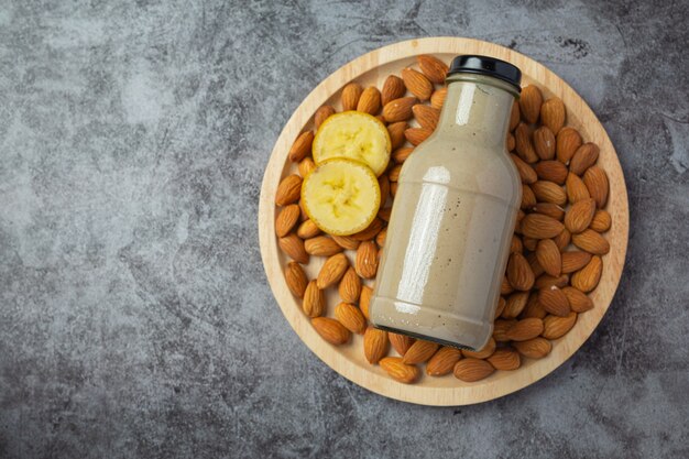 Banana almond smoothie in bottle on dark background