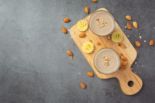 Banana almond smoothie on dark background