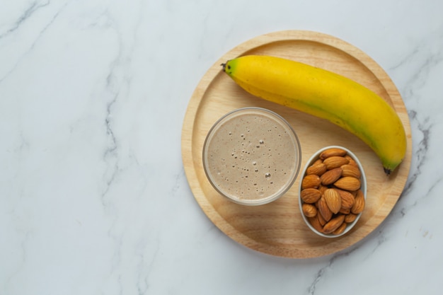 Banana almond smoothie on marble background