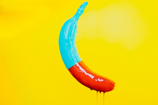 Banana in colorful paints isolated
