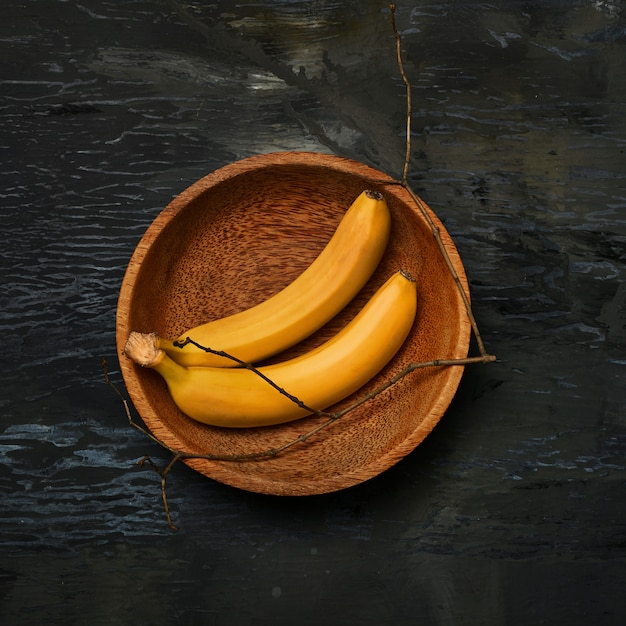 bananas on wooden bowl