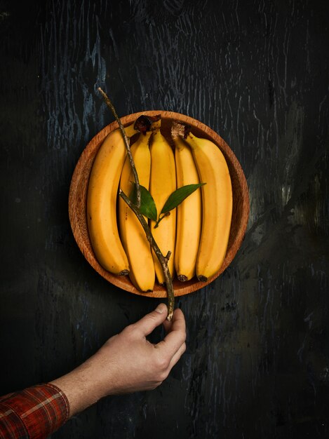 bananas on wooden bowl