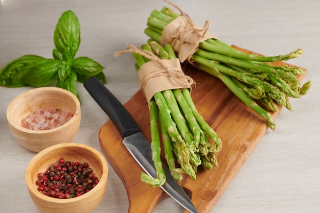 Banches of fresh green asparagus on wooden surface