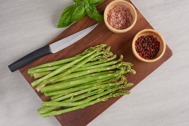 Banches of fresh green asparagus on wooden surface