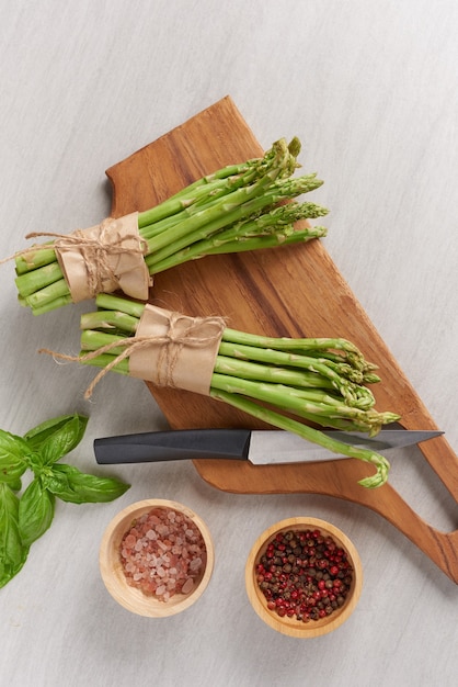 Banches of fresh green asparagus on wooden surface