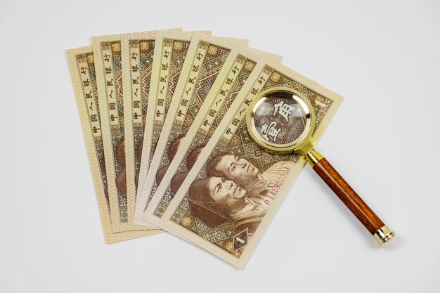 Banknotes with a magnifying glass