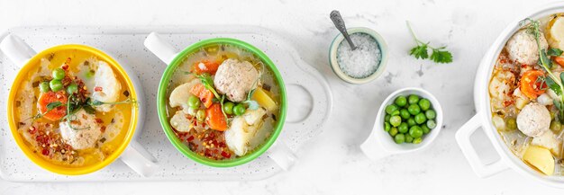 Banner Spring soup with meatballs and vegetables Top view