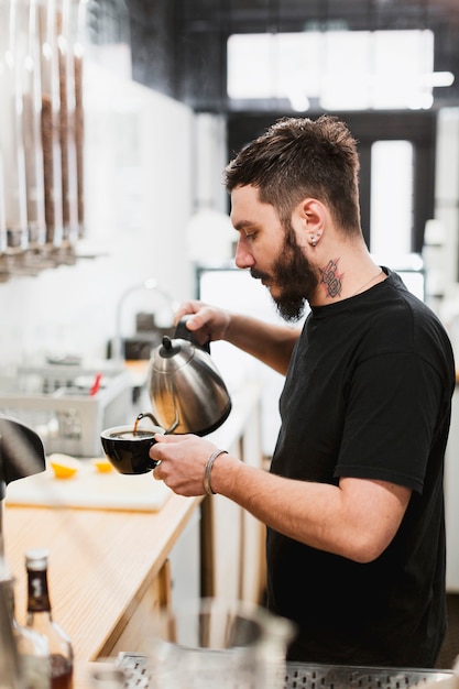 Bar concept with barman making coffee