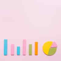 Free photo bar graph and pie chart on pink background