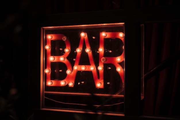 Bar sign in neon lights for night walkers